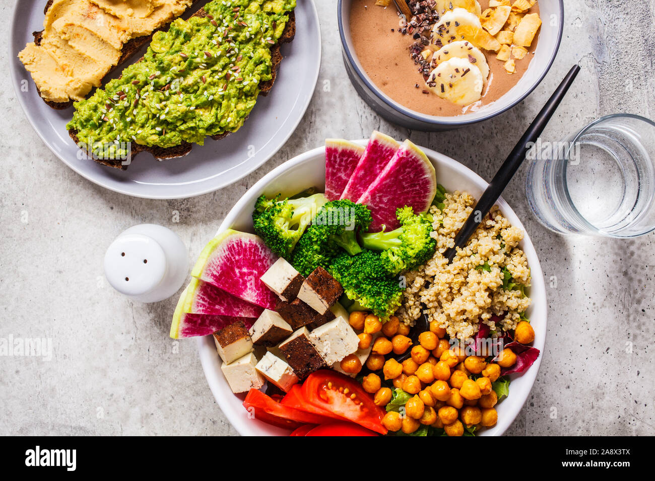 Flat lay vegan food. Chocolate smoothie bowl, Buddha bowl with tofu