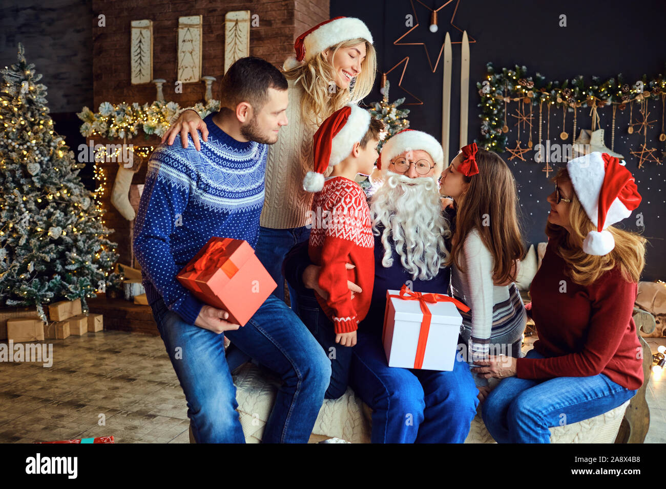 Happy family in house with christmas tree celebrates christmas. Stock Photo