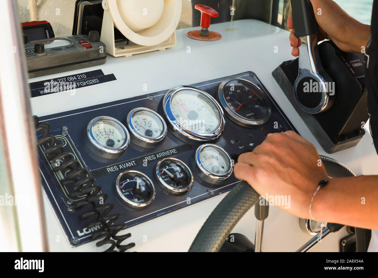 Ajaccio, France - June 30, 2015: Hands of a woman pilot are on a control panel of a fast motor boat Stock Photo