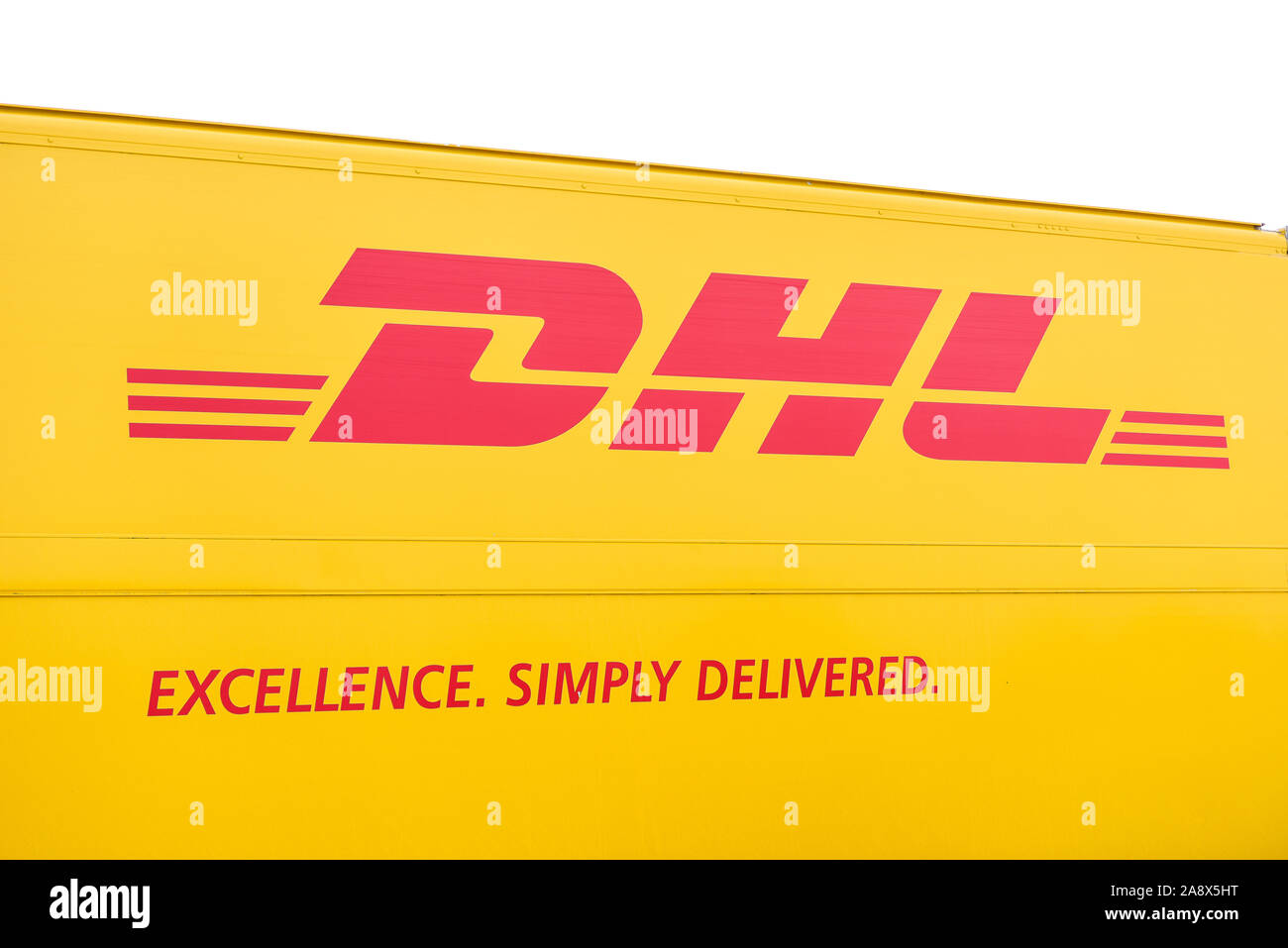 The famous DHL logo on the side of a delivery van, Excellence. Simply delivered, Postal, courier transportation and delivery services Stock Photo
