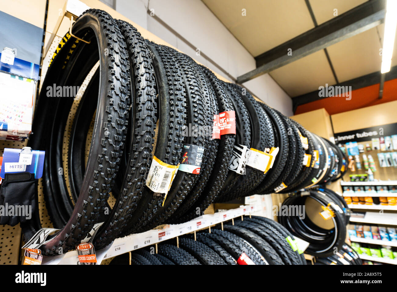 Tyres for various bicycles, bikes on sale at the Halfords store on the high  street in the city Stock Photo - Alamy