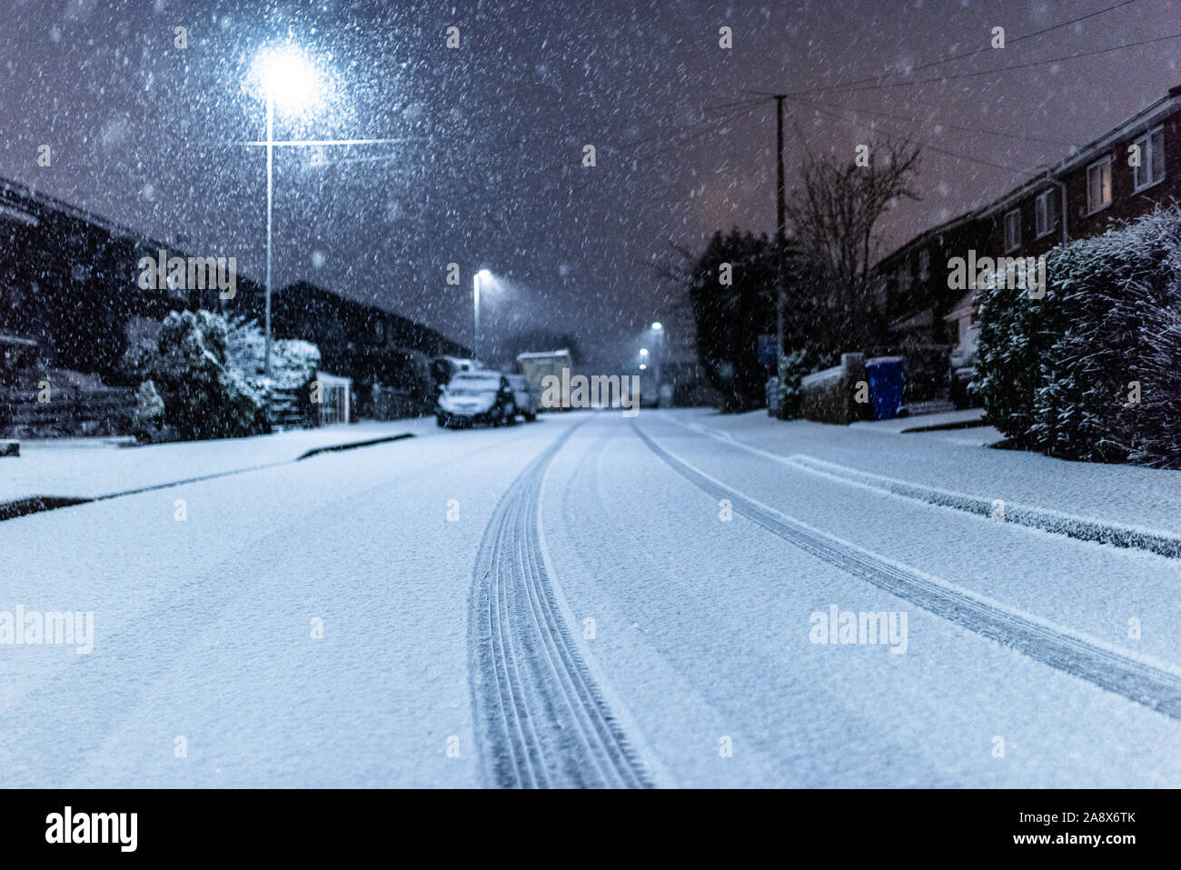 Snow covered cars, roads and houses at night in Longton, Stoke on Trent