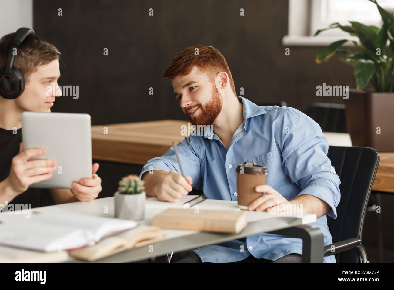 Smart student helping his classmate with homework Stock Photo