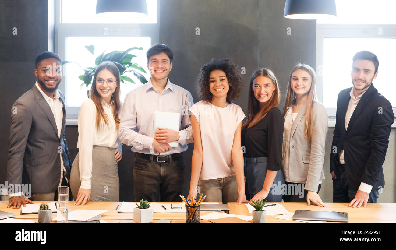 Young business team smiling to camera, having break Stock Photo