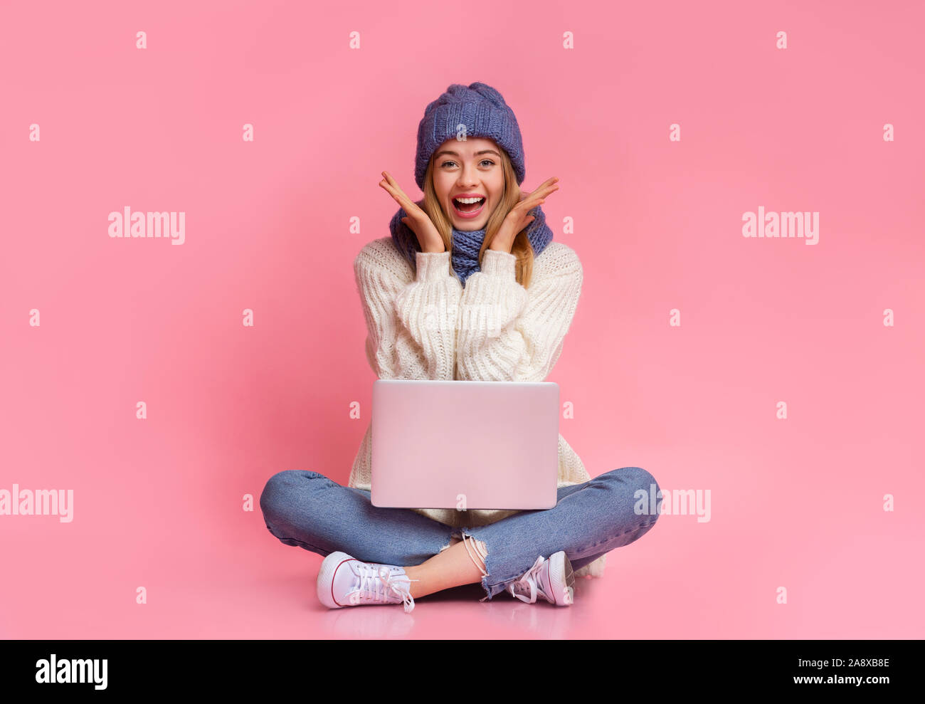 Girl with laptop expressing happiness, big sales online Stock Photo