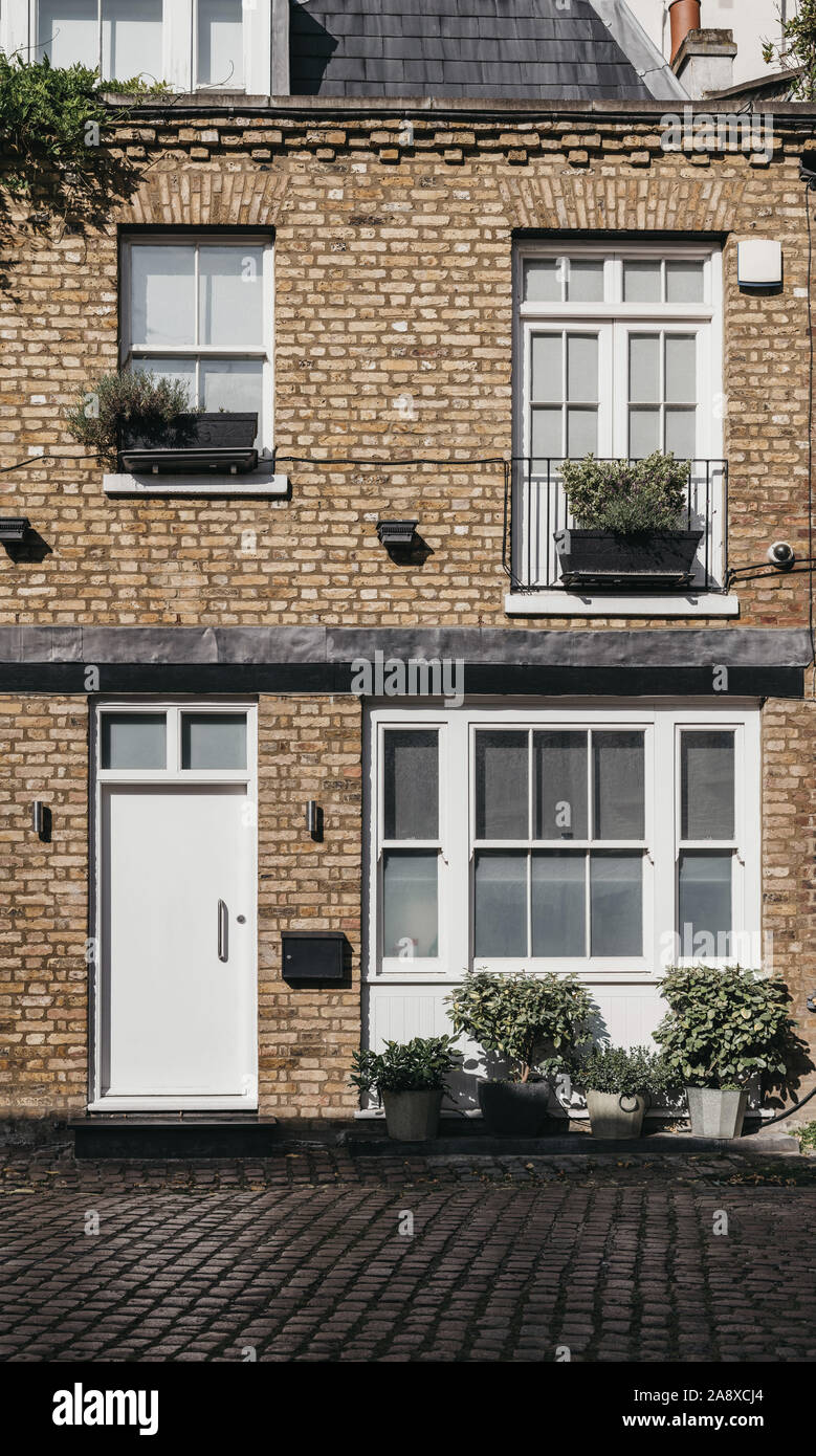 Facade of a typical mews house in London, UK. Real estate and property