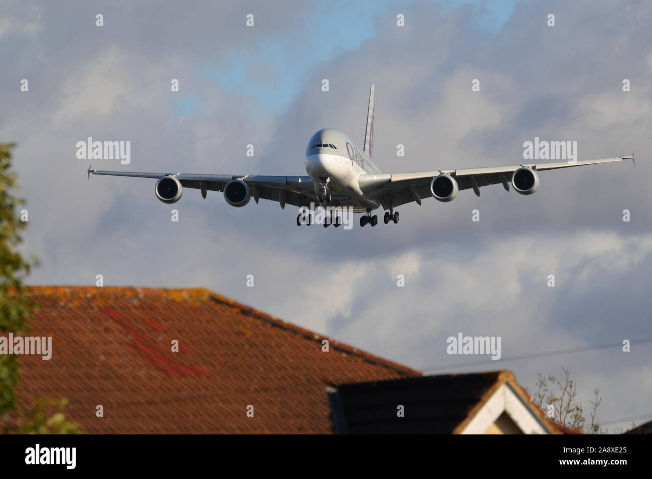 Qatar Airways Airbus A380 A7-APD flying low over the rooftops at London Heathrow Airport, UK Stock Photo