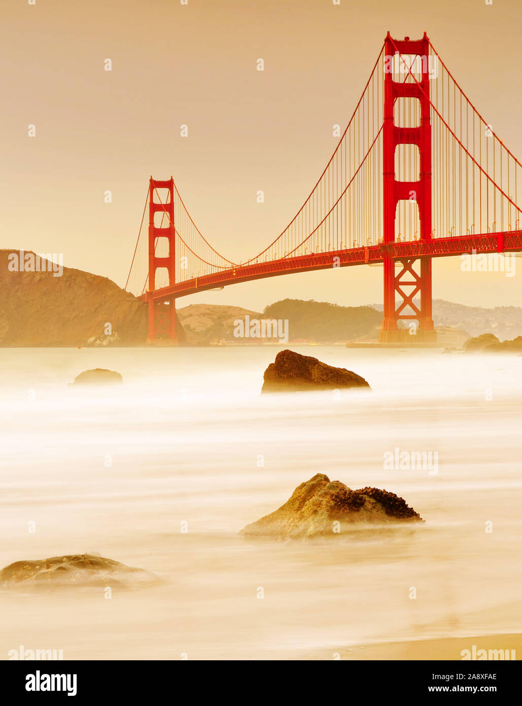View of Golden Gate Bridge from Marshall's Beach in San Francisco at sunset. Stock Photo
