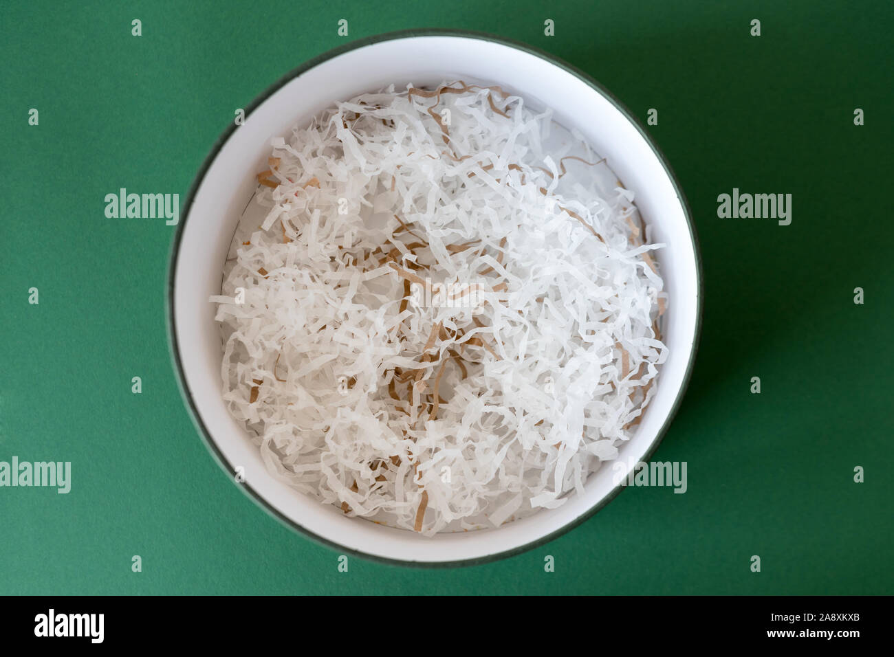 Opened gift box with decorative straw, filler, shavings, paper ribbons