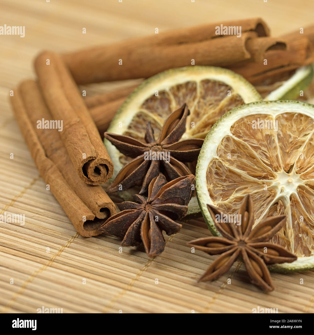Anise stars, lemon slices and cinnamon sticks Stock Photo