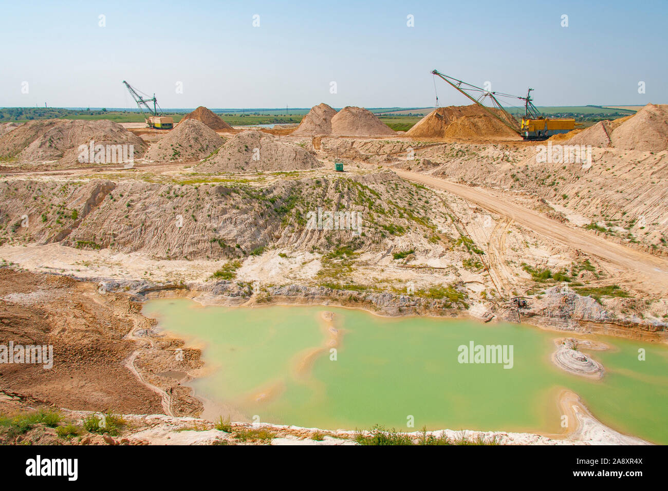A dragline walking excavator produces sand in a clay quarry. Zaporizhzhya region, Ukraine. June 2012 Stock Photo