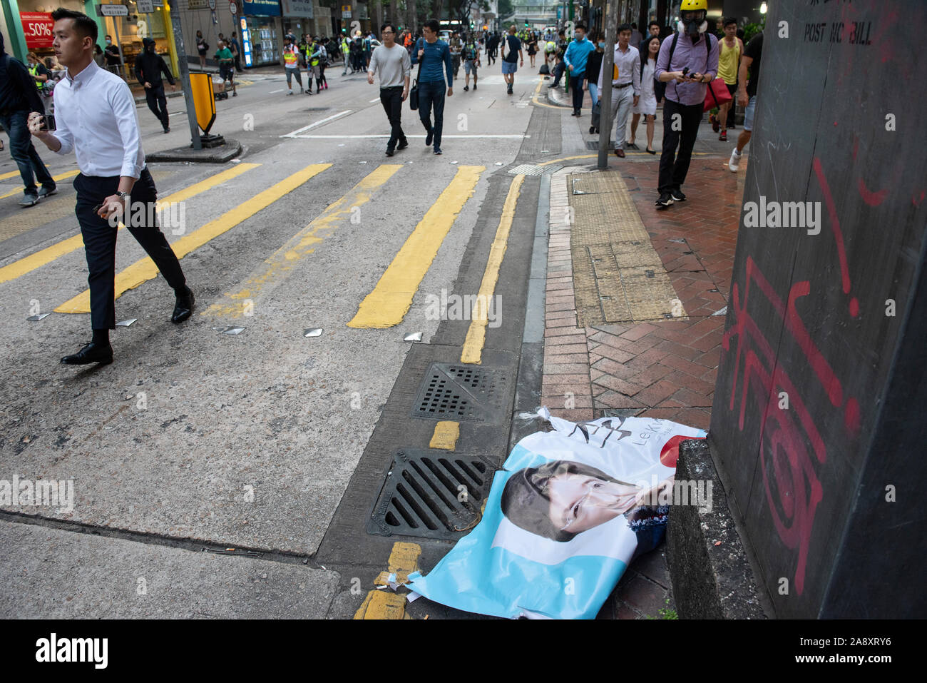 Hong Kong, China. 11th Nov, 2019. A banner of a candidate for the upcoming Hong Kong local election lays broken in the ground after it has been vandalised by the protesters during the demonstration.Anti-government protesters organized a general strike, setting up road barricades and vandalize Hong Kong´s MTR subway stations as demonstrations continued into its five months. Credit: SOPA Images Limited/Alamy Live News Stock Photo