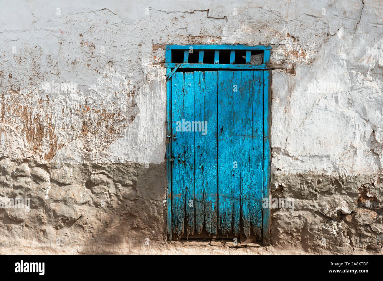 Architecture detail of a turquoise wooden door in the authentic San Blas district of Cusco city, Peru. Stock Photo
