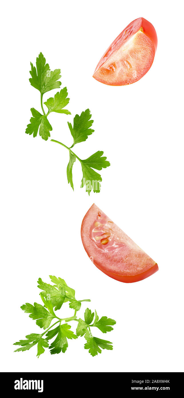 floating parsley and tomatoes isolated on white background Stock Photo