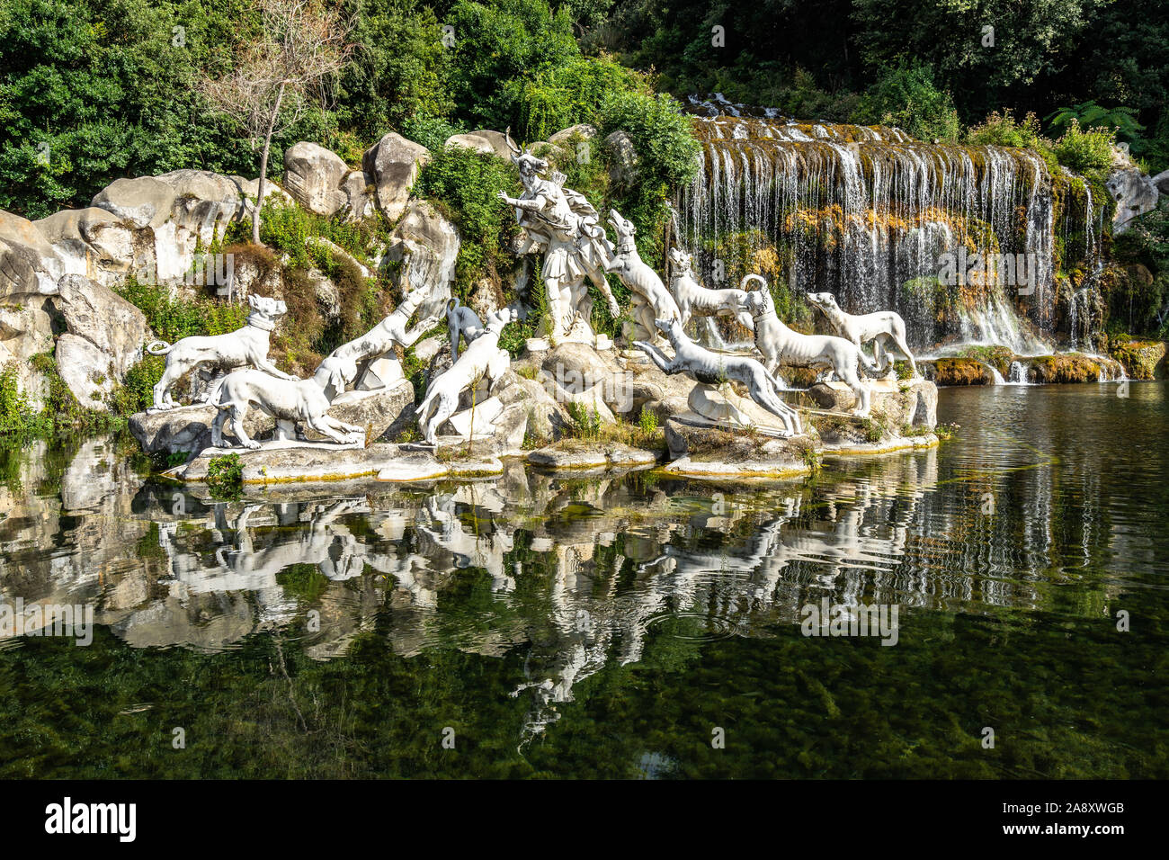 The statues of the Fountain of Diana and Acteon at Caserta Royal Palace reflecting into the waters under the  great waterfall, Campania, Italy Stock Photo