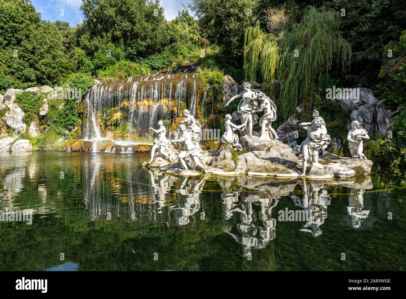 The statues of the Fountain of Diana and Acteon at Caserta Royal Palace reflecting into the waters under the  great waterfall, Campania, Italy Stock Photo