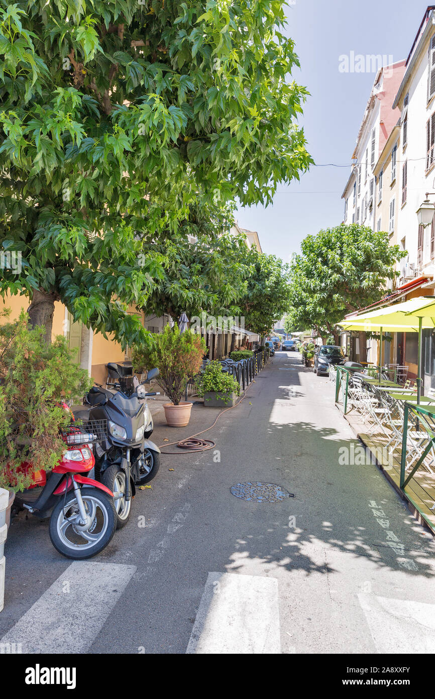 AJACCIO, CORSICA, FRANCE - JULY 13, 2019: Old town narrow medieval street located next to the Citadel with tourist cafes and restaurants. Ajaccio is t Stock Photo