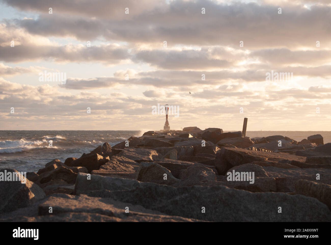 Scusset Lighthouse at Dawn with Clouds and a Jetty Stock Photo