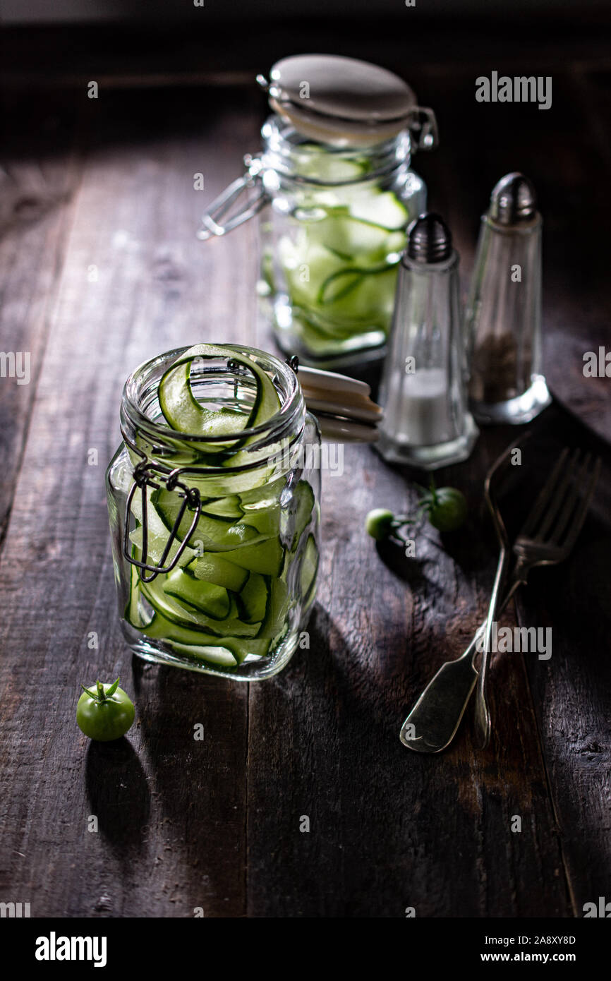 Cucumber salad in glass jars fit kitchen and delicious food a crunchy snack Stock Photo