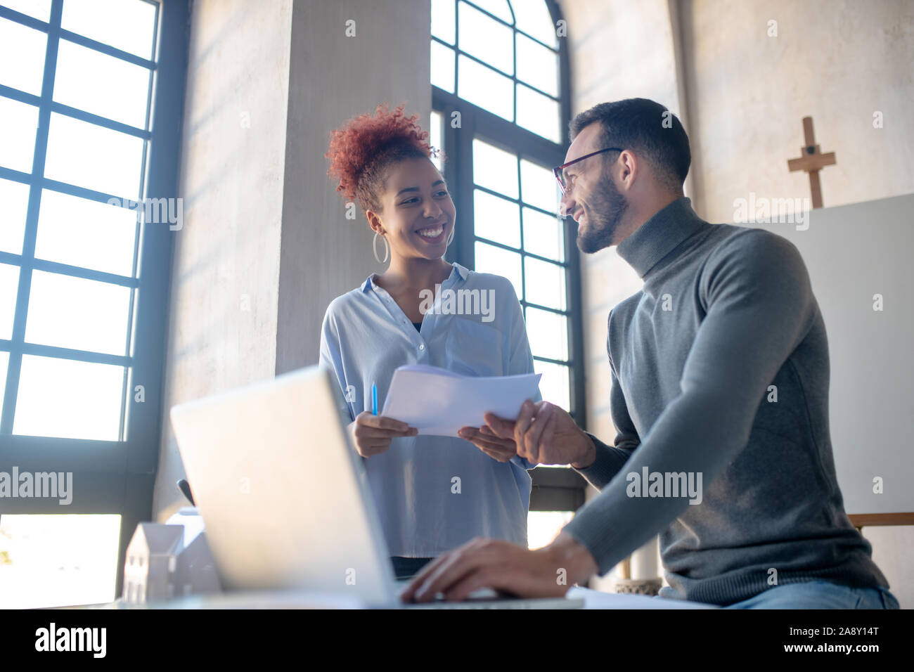 Two designers smiling while working on project together Stock Photo