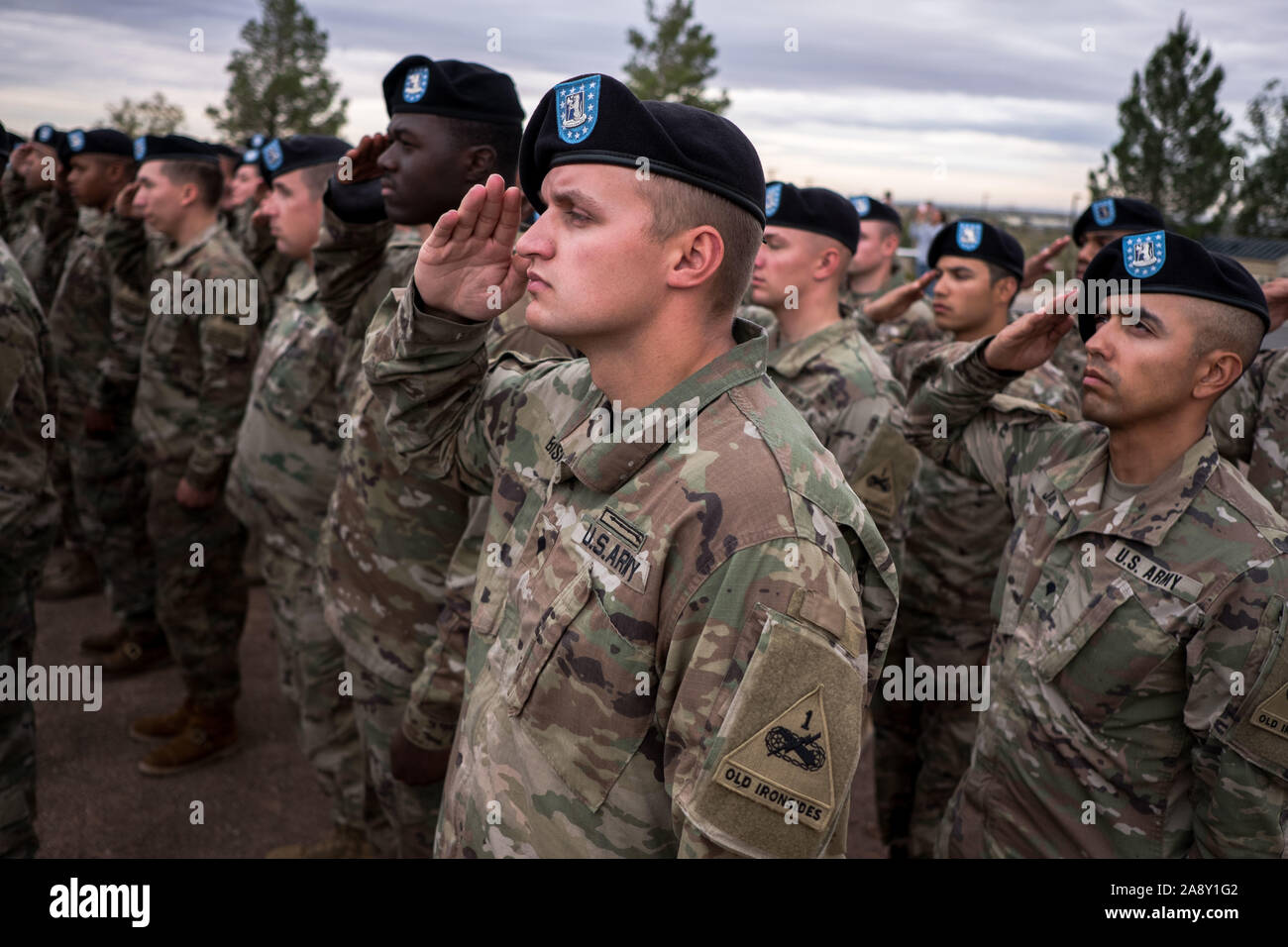 El Paso, Texas, USA. 11th Nov, 2019. Soldiers of 1st Battalion, 77th Armor Regiment, 3rd Armored Brigade Combat Team ''Bulldog'', 1st Armored Division, salute an American flag as it is raised during a Veteran's Day celebration in El Paso, Texas. Credit: Joel Angel Juarez/ZUMA Wire/Alamy Live News Stock Photo