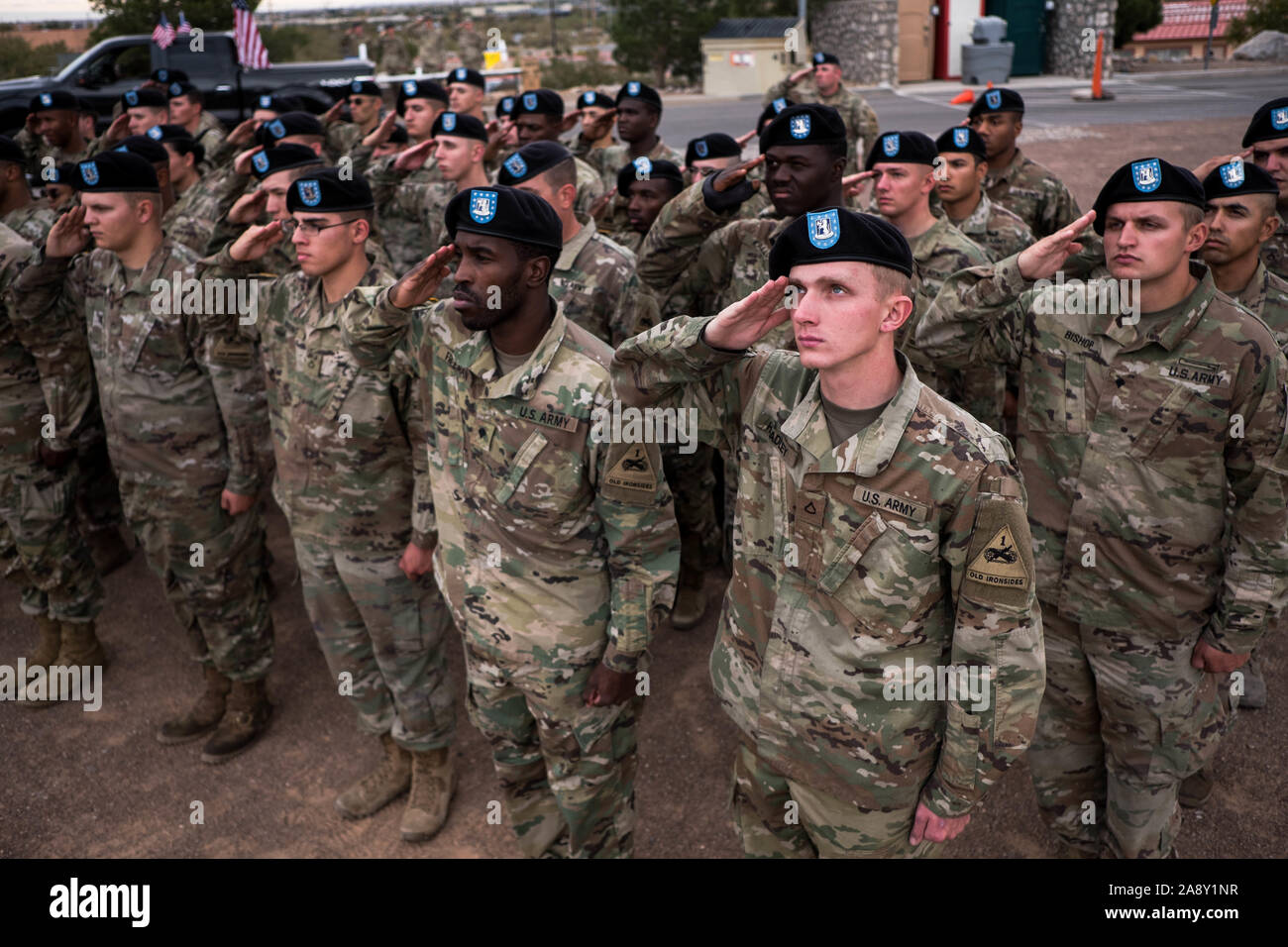 El Paso, Texas, USA. 11th Nov, 2019. Soldiers of 1st Battalion, 77th Armor Regiment, 3rd Armored Brigade Combat Team ''Bulldog'', 1st Armored Division, salute an American flag as it is raised during a Veteran's Day celebration in El Paso, Texas. Credit: Joel Angel Juarez/ZUMA Wire/Alamy Live News Stock Photo