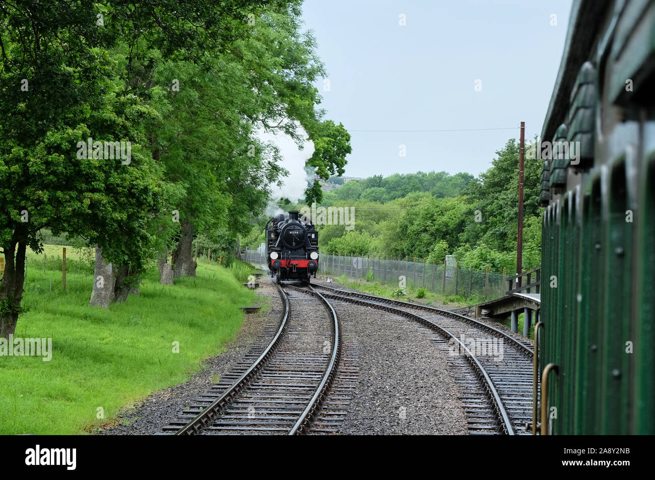 Head on view of the Ivatt class steam locomotive No 41298 returning to pick up carriages in the greenery of the isle of wight Stock Photo