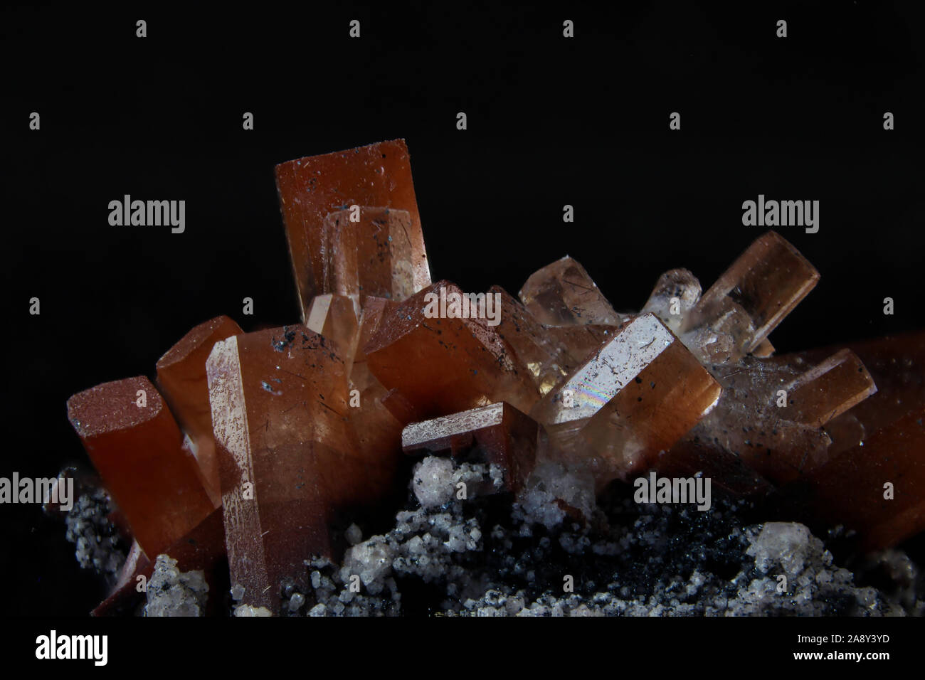 Rock matrix with small crystals and orange and clear topaz Stock Photo