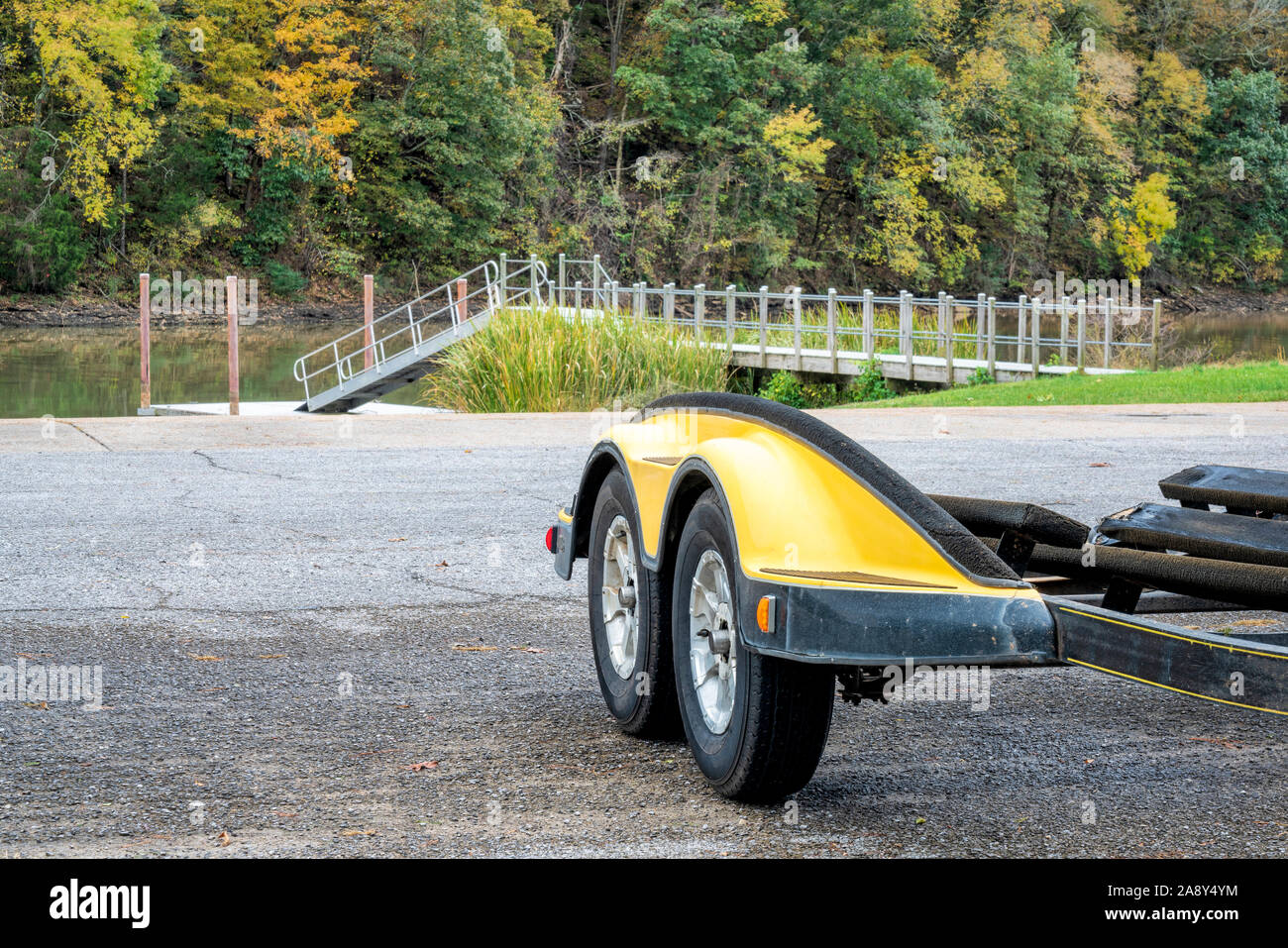 trailer, dock and boat ramp on Tennessee River in fall scenery, Colbert