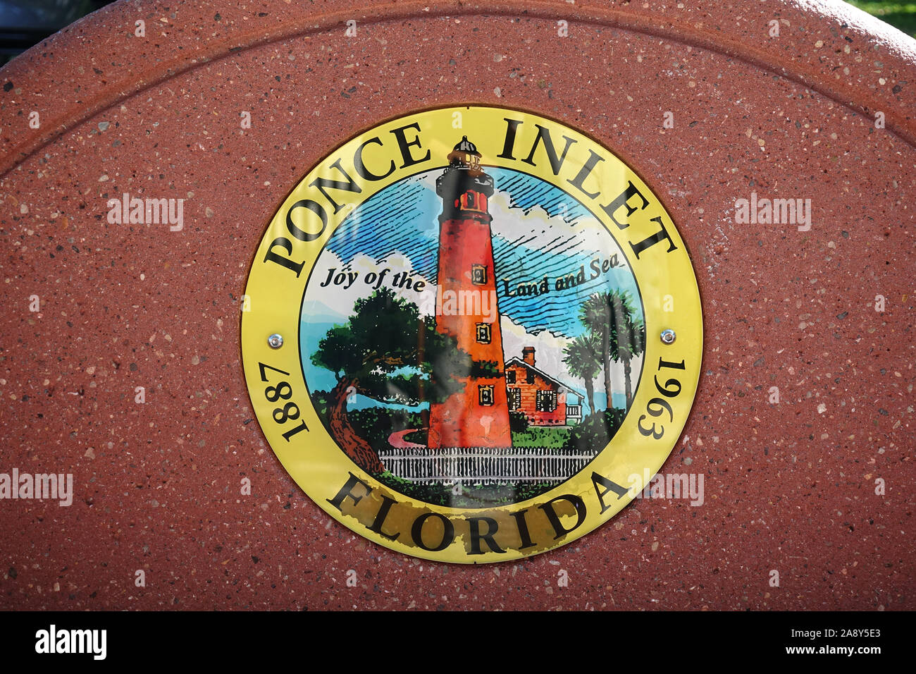 Local Government Ponce Inlet Seal Plaque On A Public Bench In Ponce Inlet Showing The Famous Lighthouse Florida USA Stock Photo