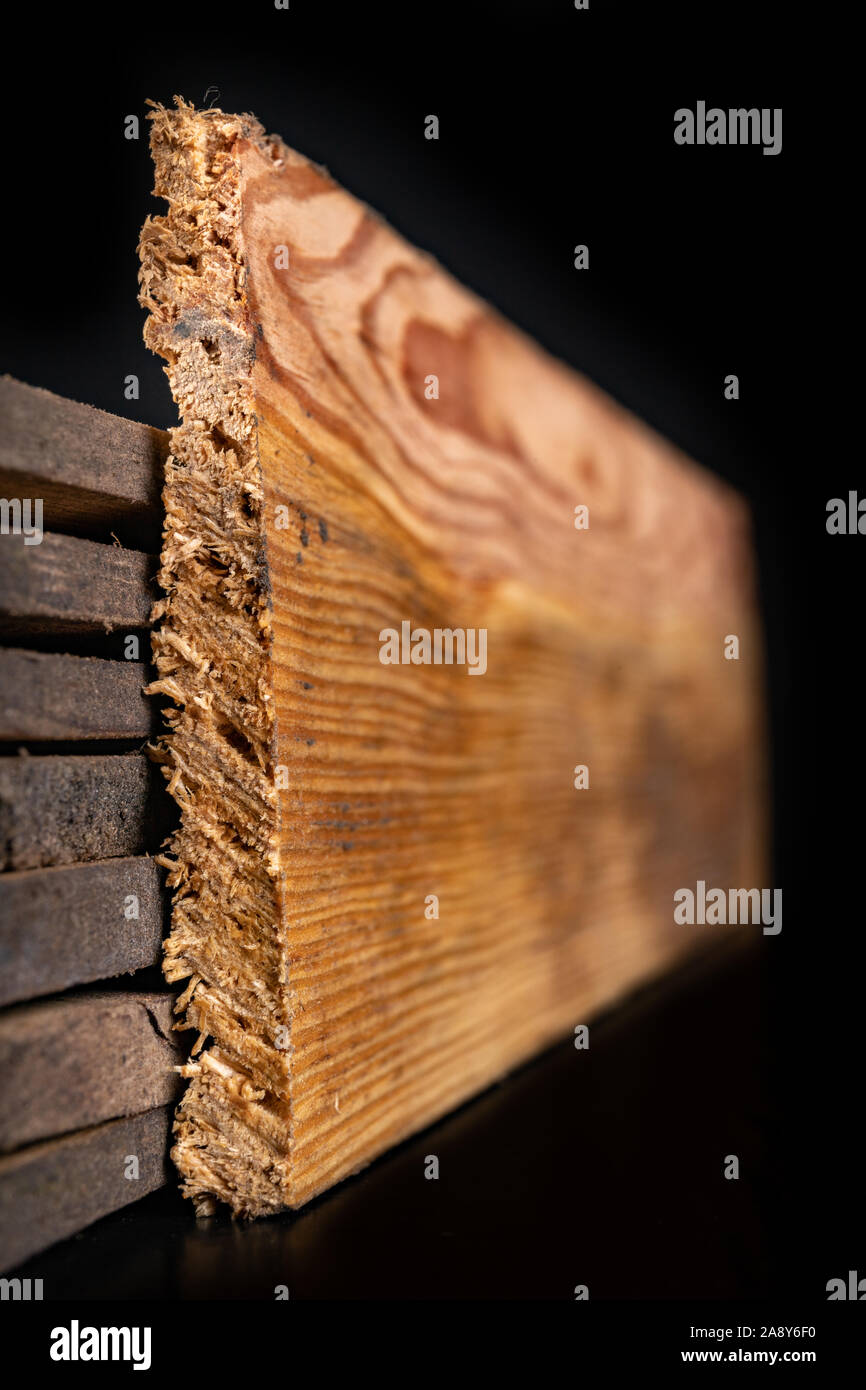 Raw wooden boards. Heavily jagged wood edges. Dark background Stock