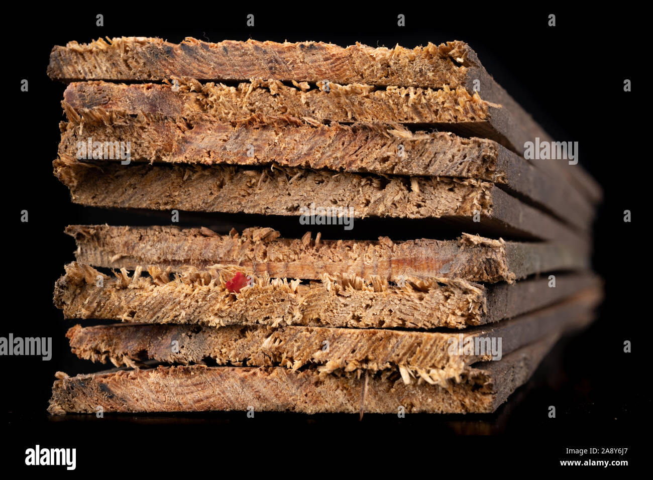 Raw wooden boards. Heavily jagged wood edges. Dark background Stock