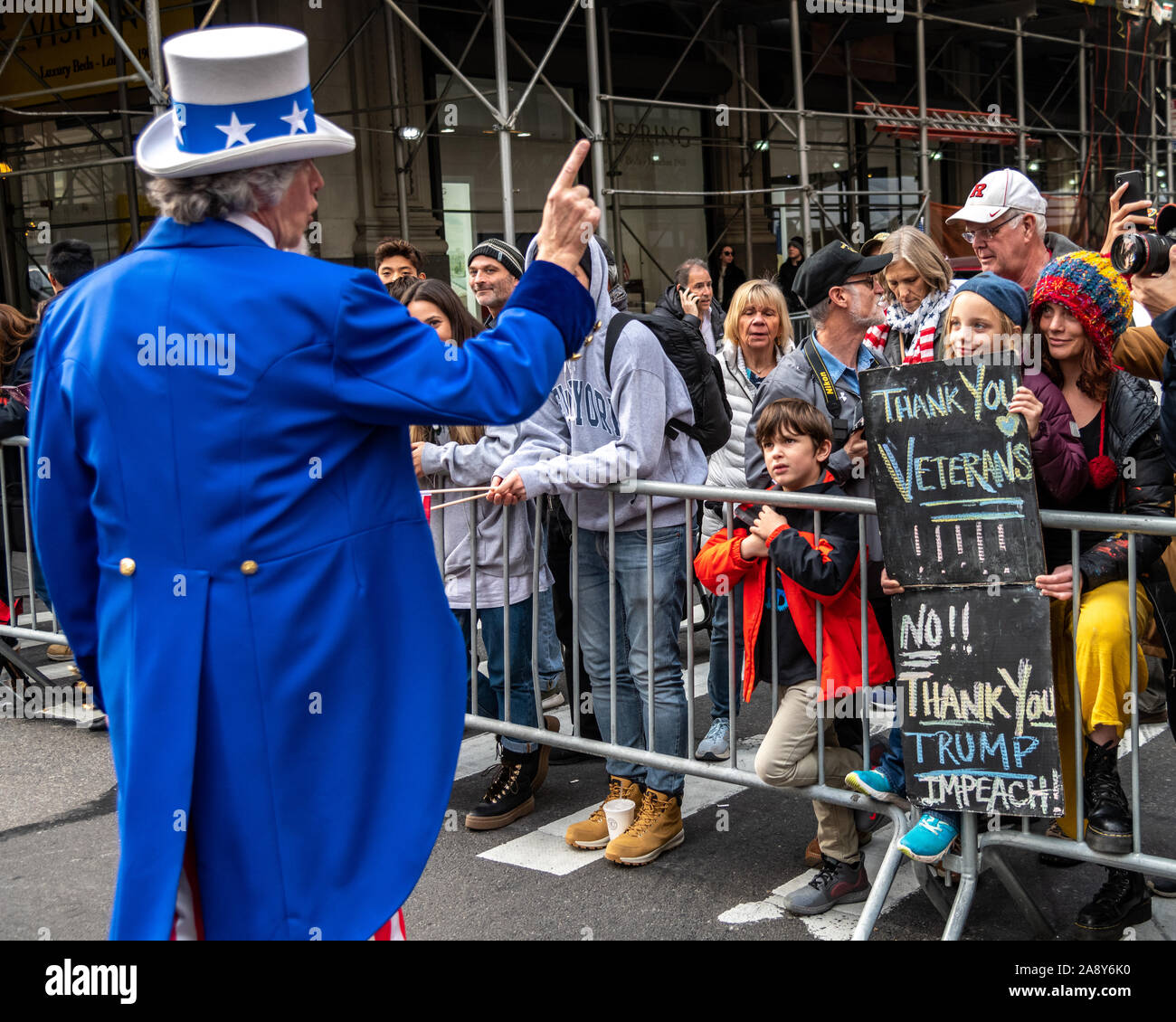 New York, USA,   11 November 2019.  An Uncle Sam impersonator interacts with public displaying anti-Trump signs at the Veterans Day Parade in New York City.  Credit: Enrique Shore/Alamy Live News Stock Photo