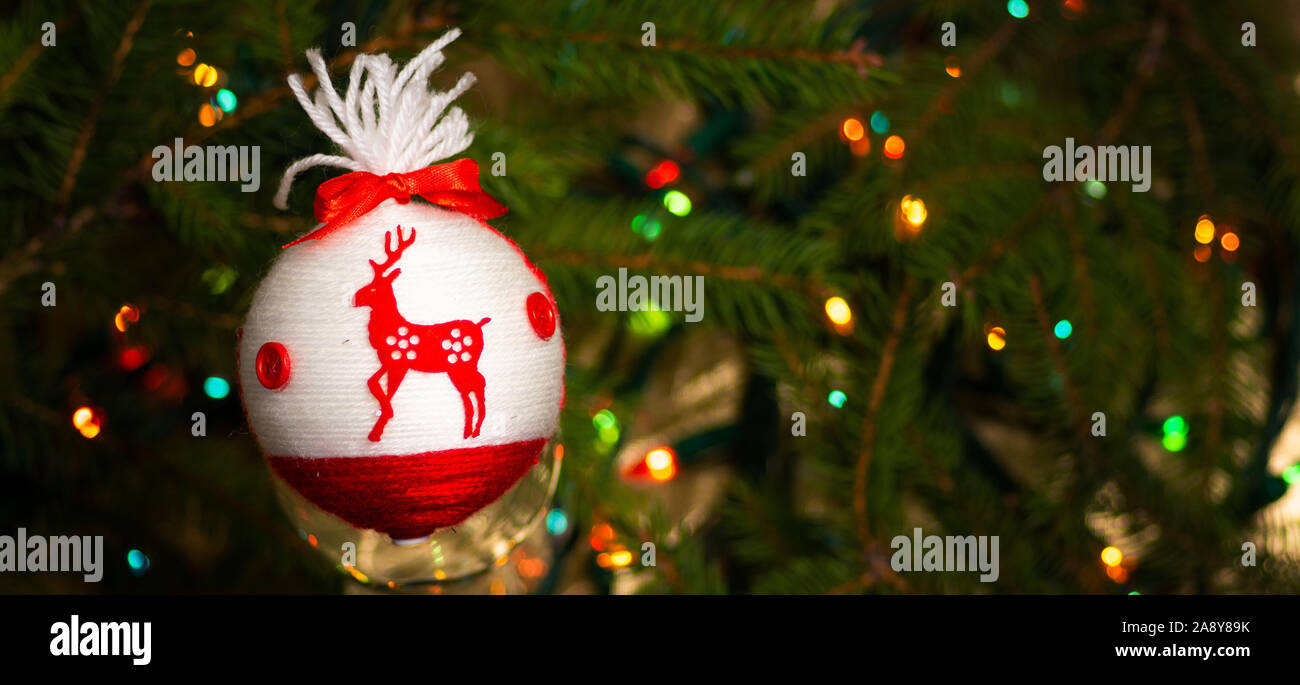 Festive decorations hanging from the Christmas tree closeup Stock Photo