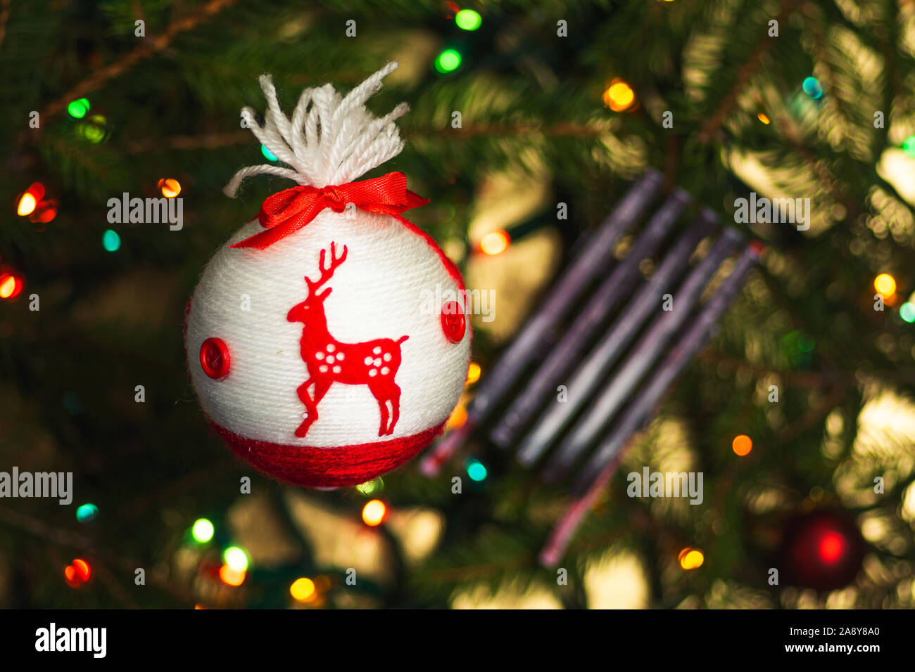 Festive decorations hanging from the Christmas tree closeup Stock Photo