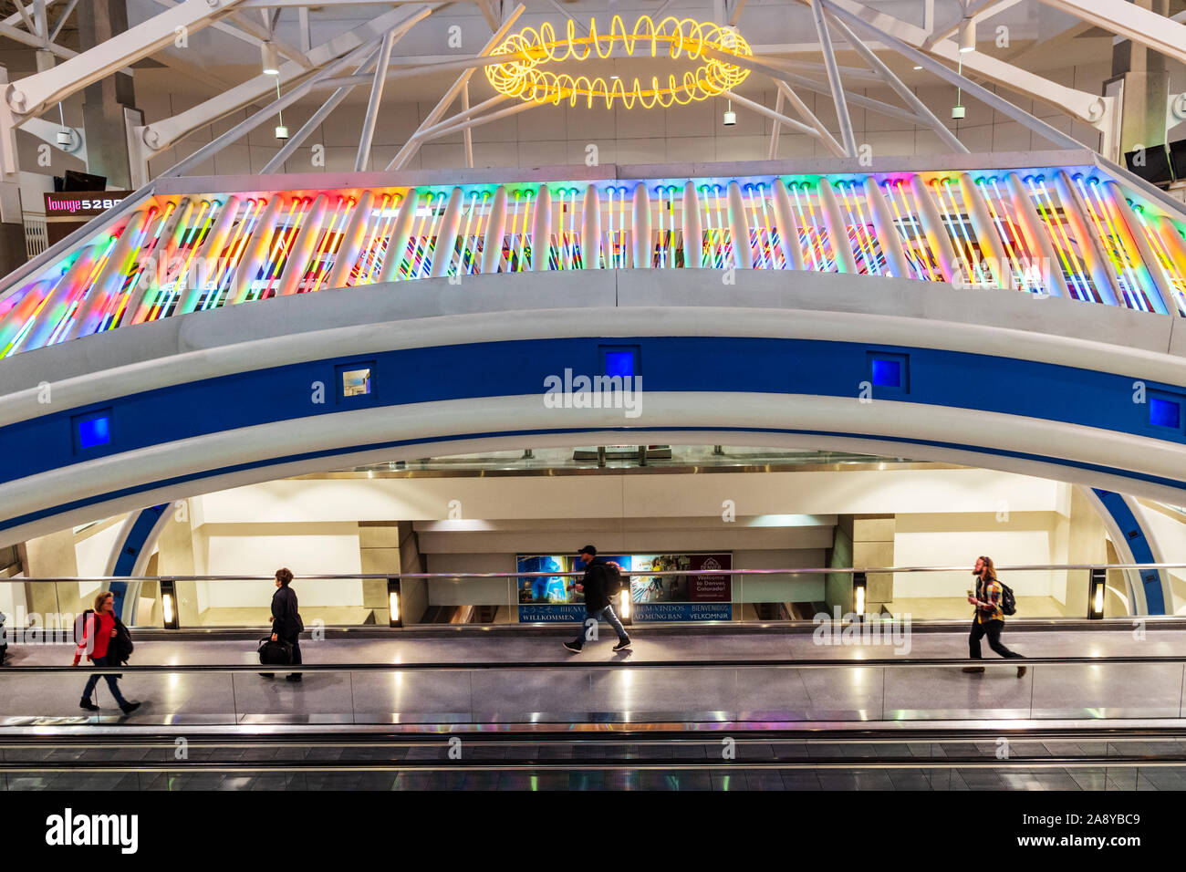 Colorful neon lights decorate a people mover at Denver International