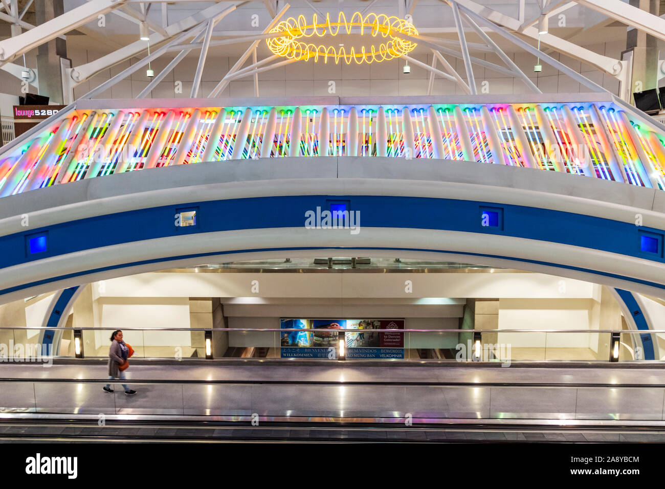 Colorful neon lights decorate a people mover at Denver International