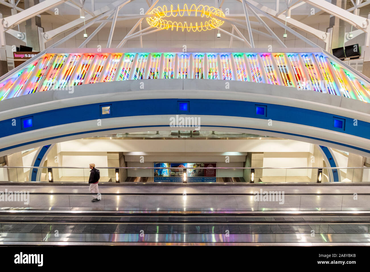 Colorful neon lights decorate a people mover at Denver International