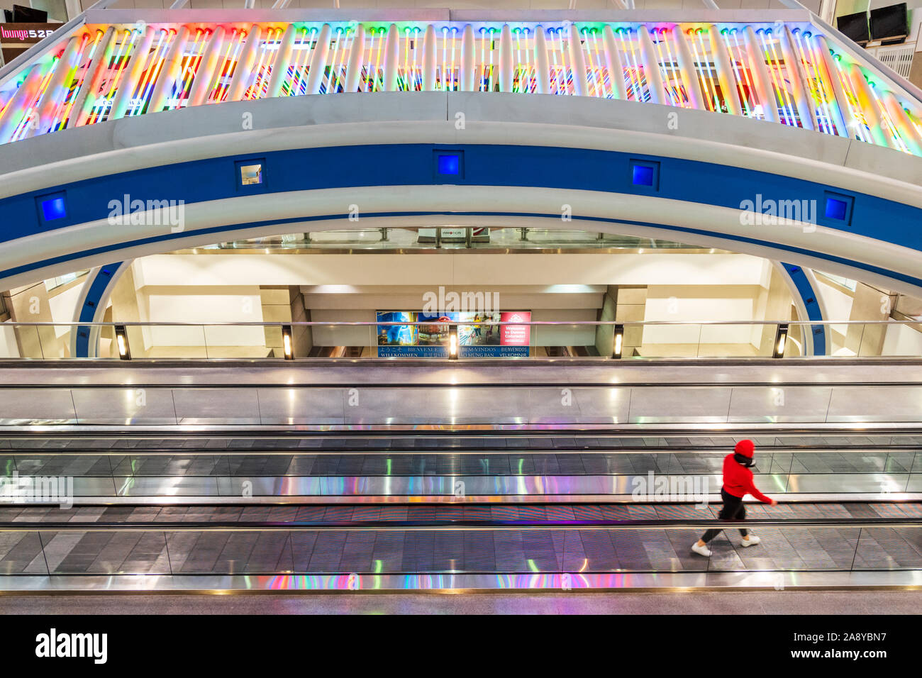 Colorful neon lights decorate a people mover at Denver International