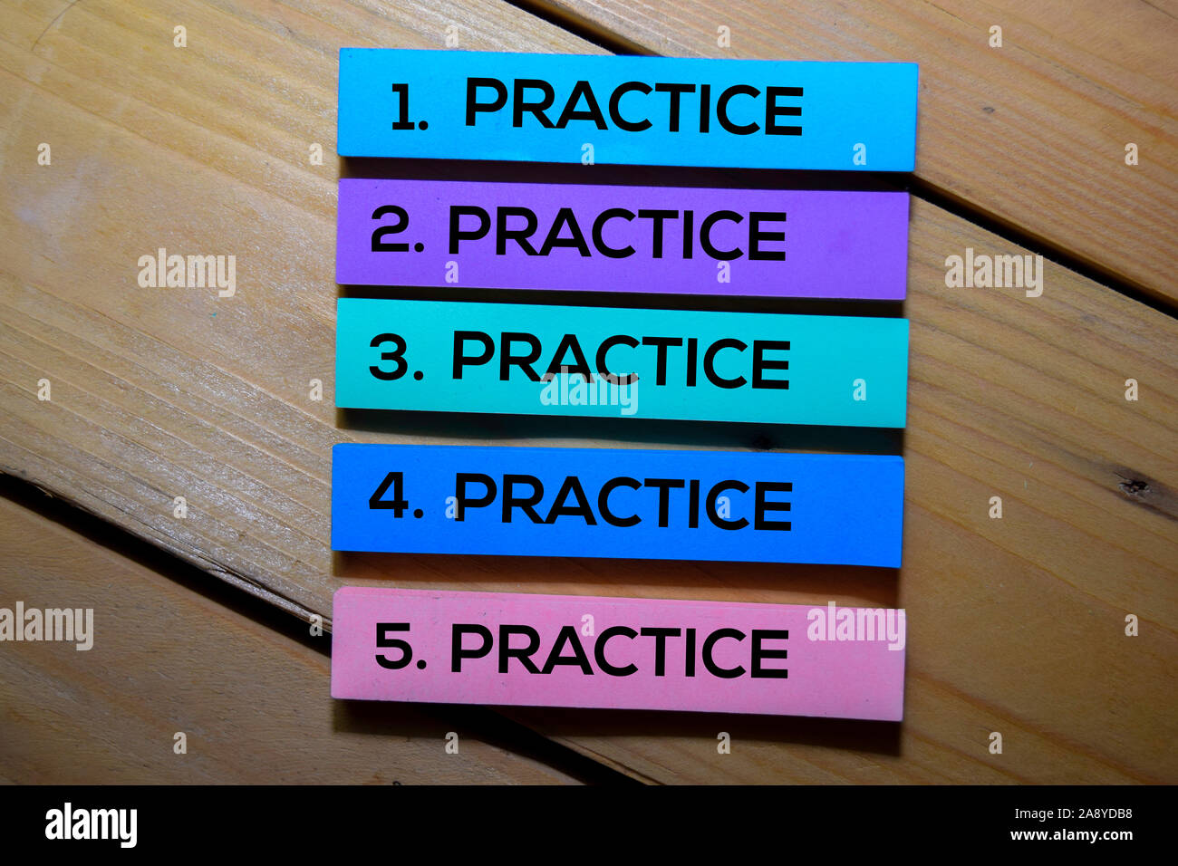 Practice. Practice. Practice. Practice. Practice text on sticky notes isolated on the tables Stock Photo