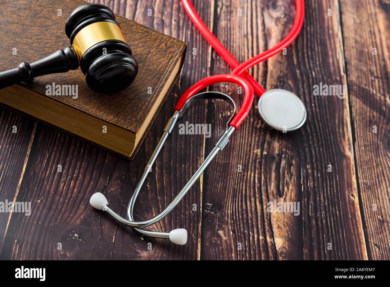 Medical malpractice and errors makes doctors and patients go to court, gavel on legal books. Stock Photo