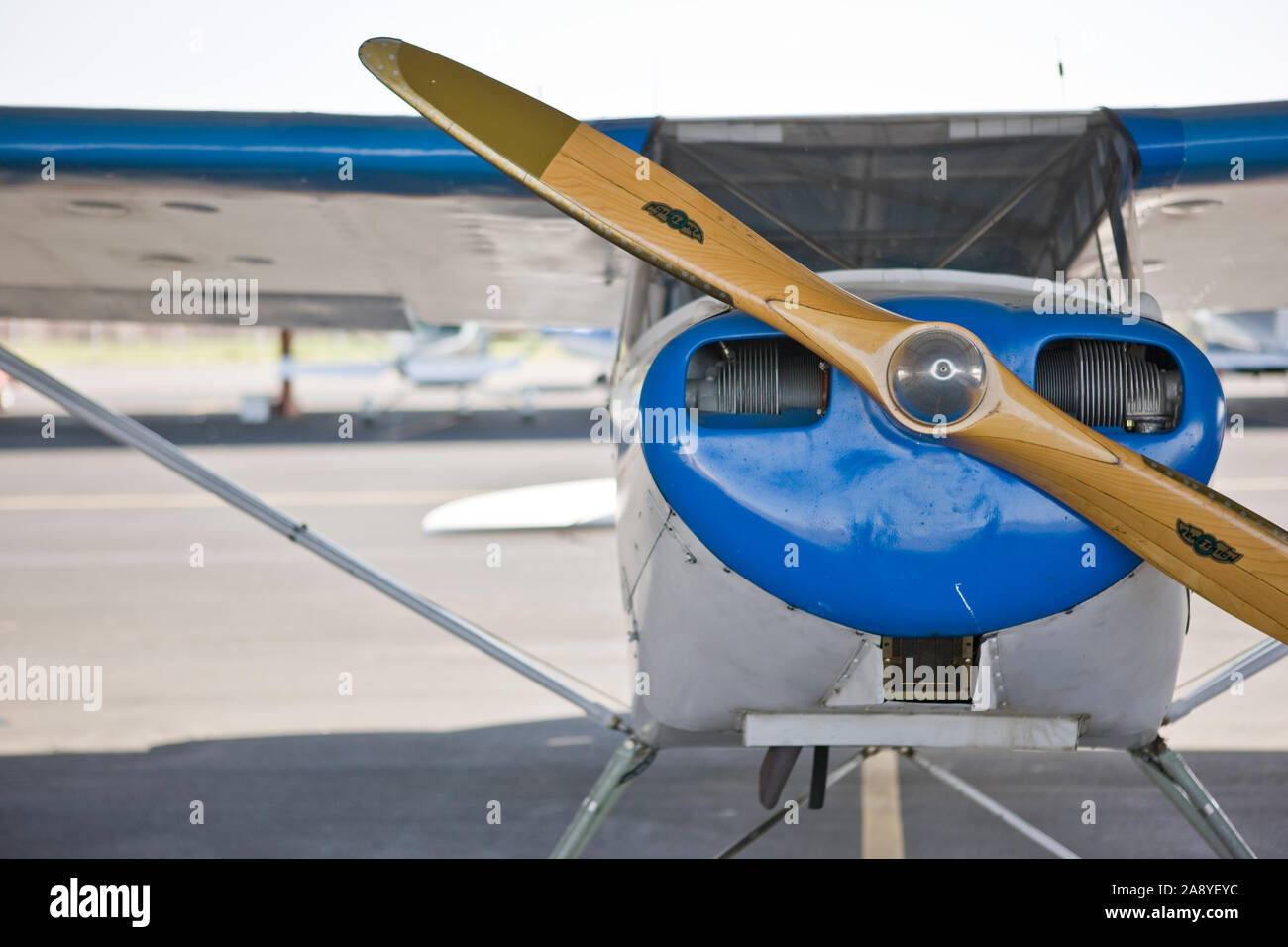 Propeller on a vintage aircraft sitting stationary on an airport tarmac outdoors in the sunshine. Stock Photo