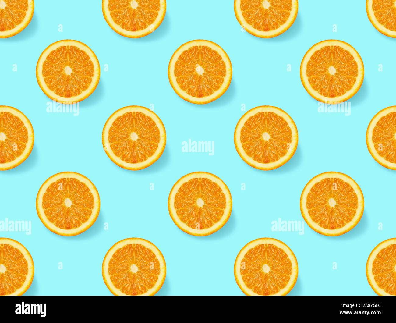 Seamless  pattern with oranges slices on blue  background. Flat lay, top view.Creative  concept.Isometric view. Stock Photo