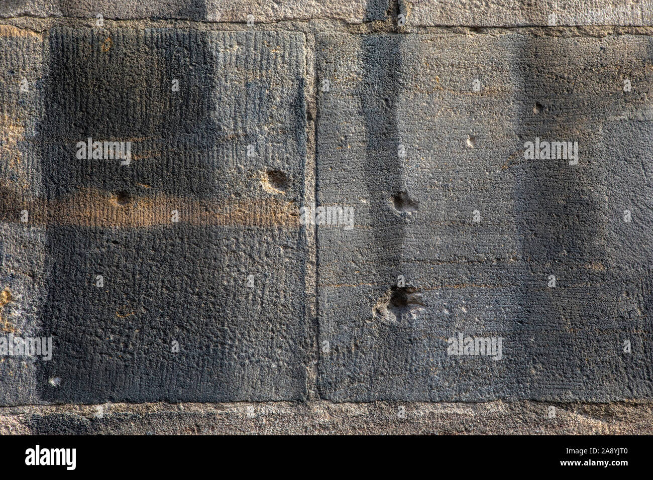 Close-up of bullet holes and shrapnel damage from the Second World War, on the exterior of St. Lorenz Kirche in the historic city of Nuremberg, German Stock Photo