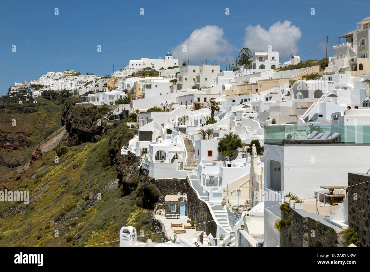 The village of Santorini on a volcanic caldera, with its whitewashed Cycladic Architecture  on a sunny morning. Stock Photo