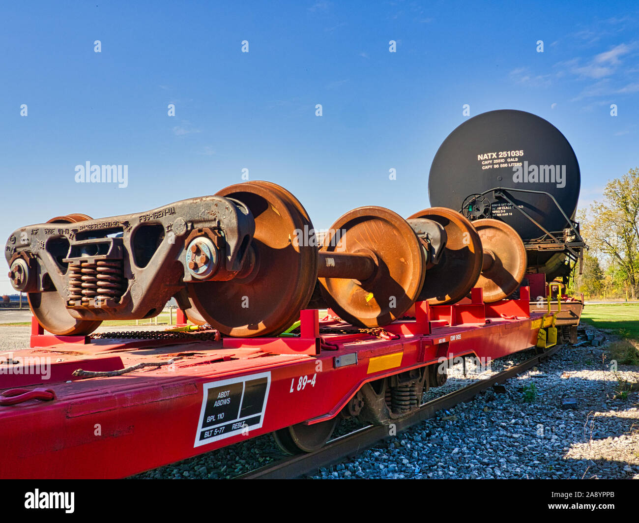 Railroad car trucks being transported on flat bed railroad car Stock