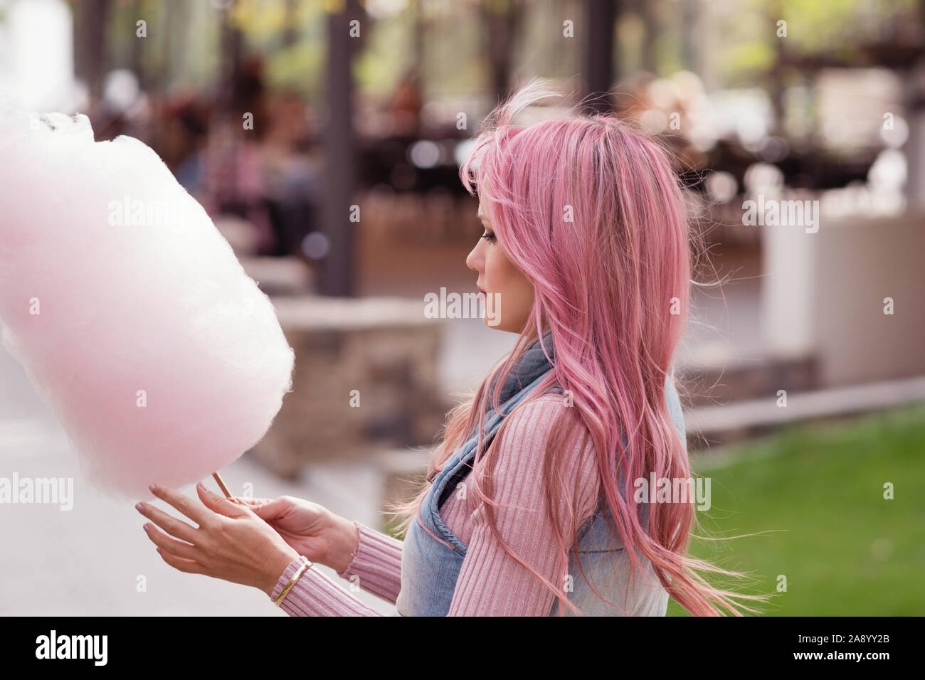 Adorable young woman with long pink hair eats and poses with sugar pink candy cotton. Concept happy times. Carefree girl. Good mood Stock Photo - Alamy Adorable young woman with long pink hair eats and poses with sugar pink candy cotton. Concept happy times. Carefree girl. Good mood Stock Photo - Alamy