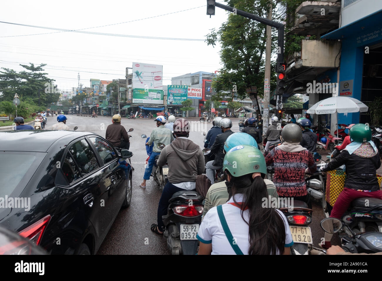 Motorbike and car traffic at a red light in Qui Nhon /Quy Nhon, Vietnam Stock Photo