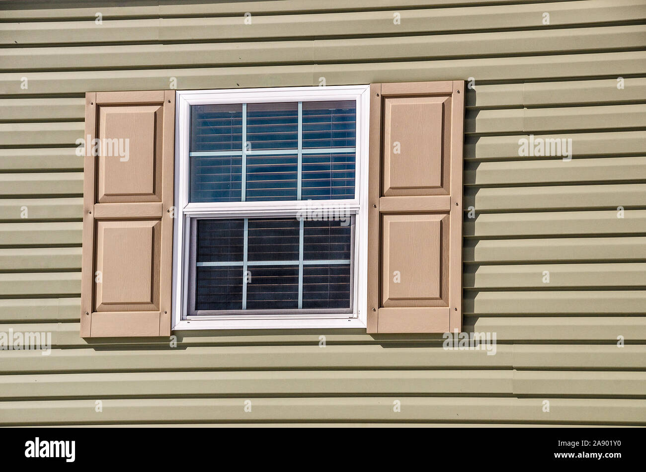 Vinyl window and siding on a new manufactured home with shutters Stock