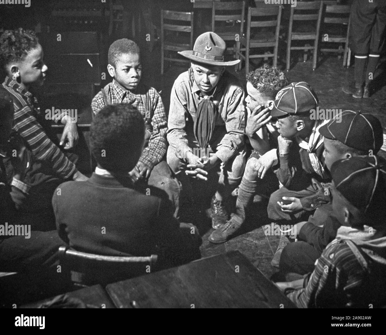 A group of nine African American boys, some wearing Cub Scout uniforms
